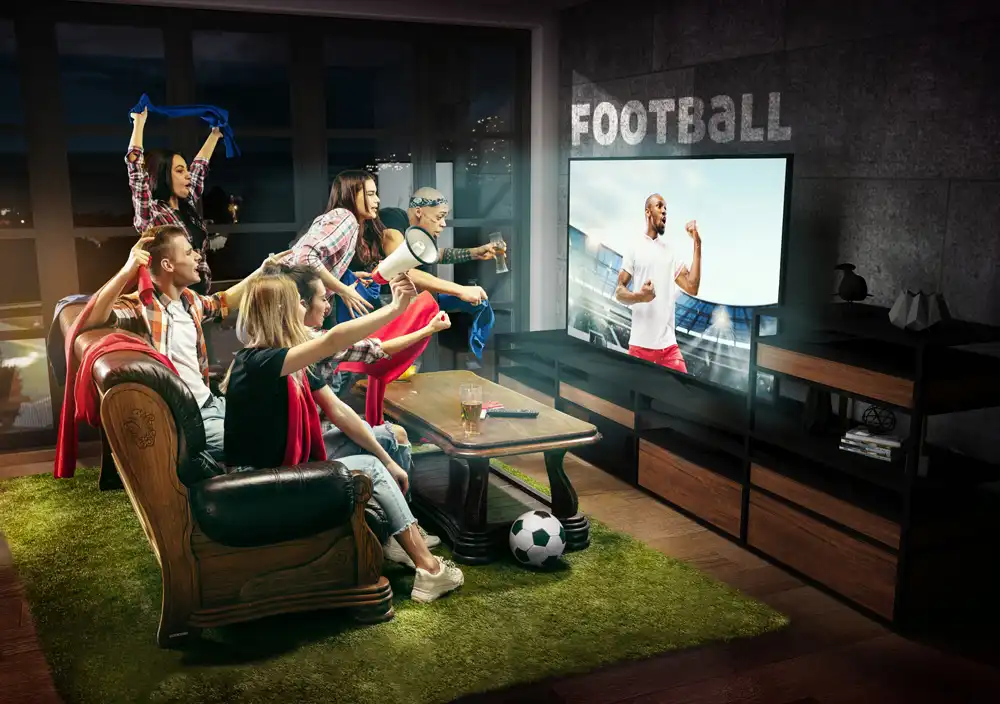 Büyük ekranda futbol izleyen izleyiciler